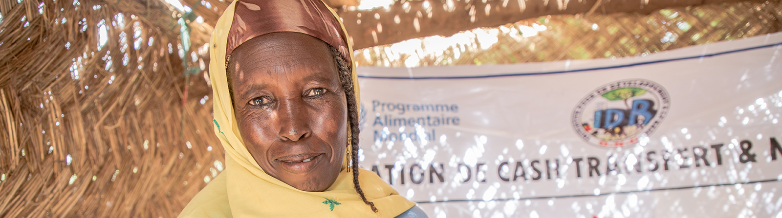 African woman displaying receipt from her cash transfer