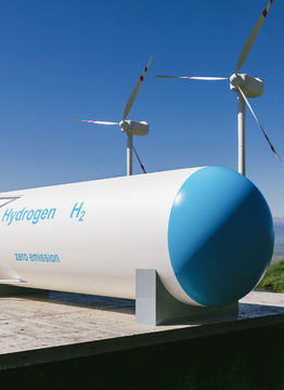 Tank for hydrogen storage and windmills in the background