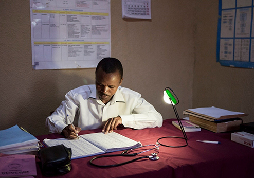 doctor working under the light of a lamp