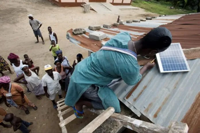 Togolese Solar Mamas successfully install a solar system, making their village clinic off-grid. Photograph by Lar Bolands.