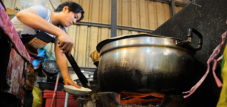 Laos, woman cooking