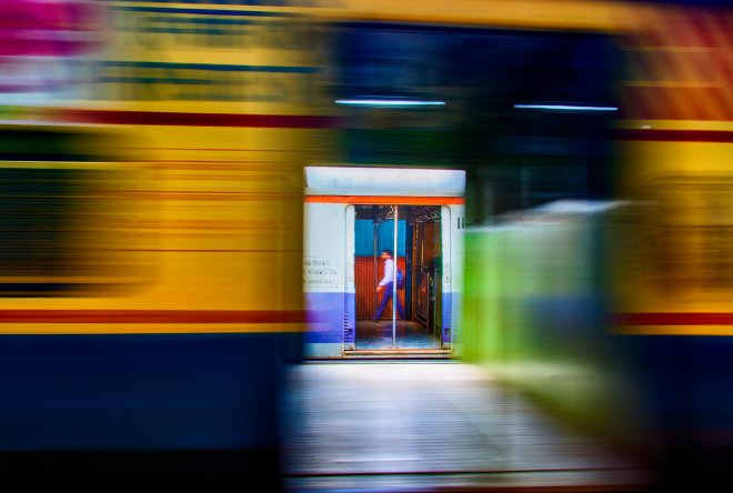 Person walking over subway platform in blurry motion