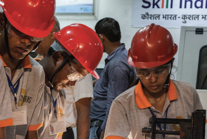 People wearing red hard hats and safety gear gathered together indoors or at a worksite