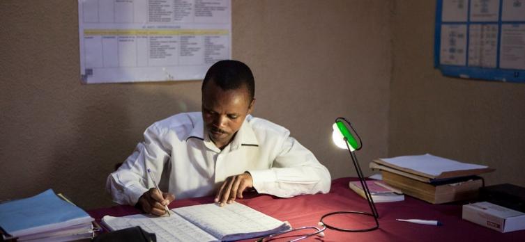 image by Mobisol doctor working under the light of a lamp