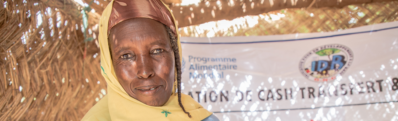 African woman displaying receipt from her cash transfer