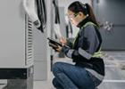 woman, engineer, installing mobile batteries