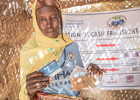 African woman displaying receipt from her cash transfer