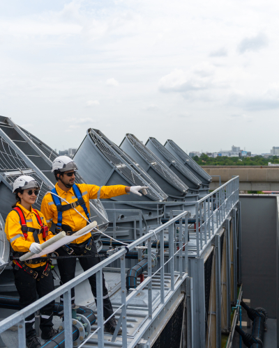 Construction worker performing cooling system repair 