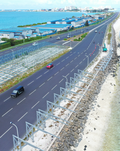 Highway bordered by turquoise water on both sides