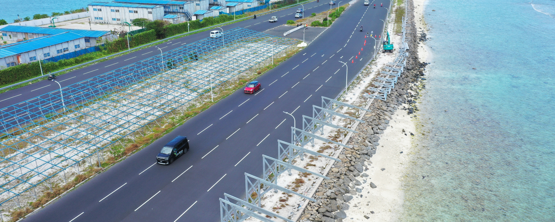 Highway bordered by turquoise water on both sides