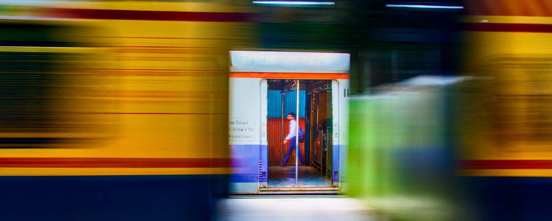 Person walking on a subway platform in blurred motion