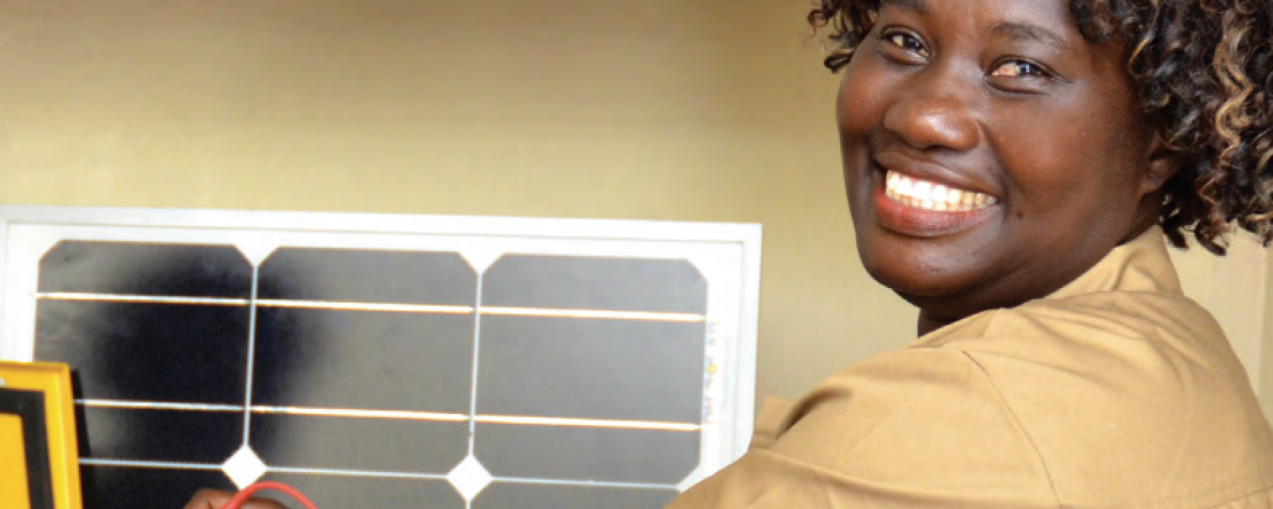 Person smiling while working near a technical setup