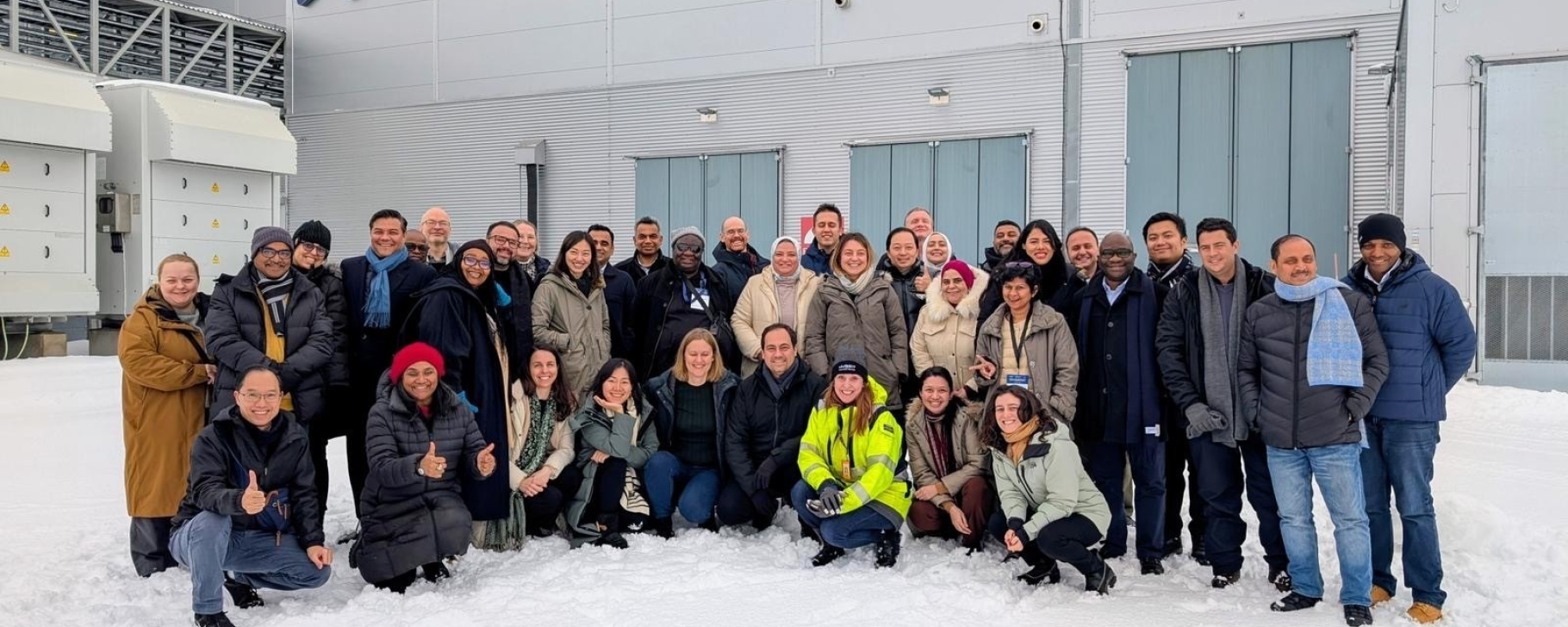Group of people in a snow-covered steel plant