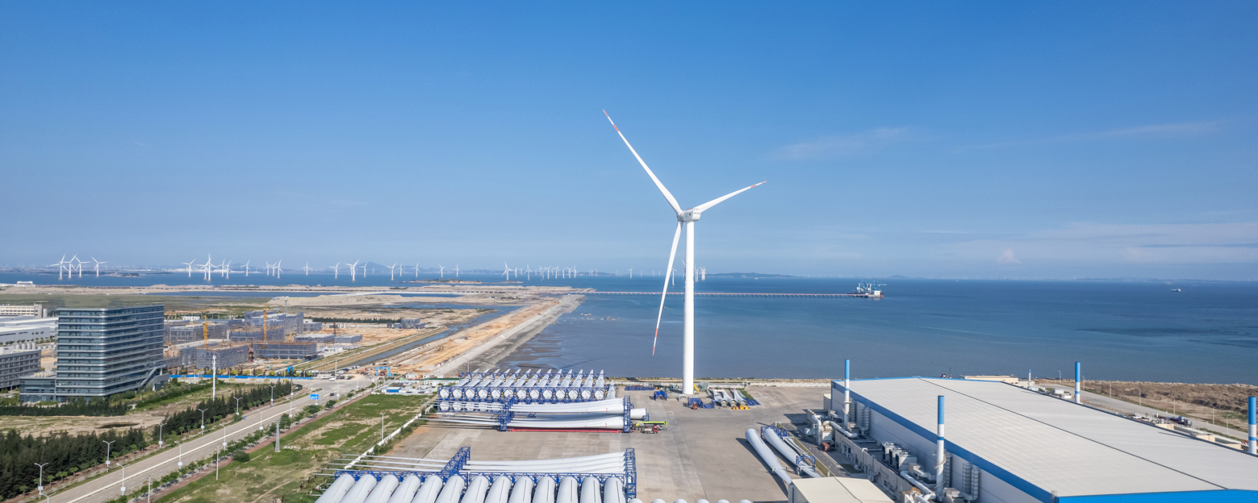 Aerial view of wind turbine propeller blades and wind power on the seaside