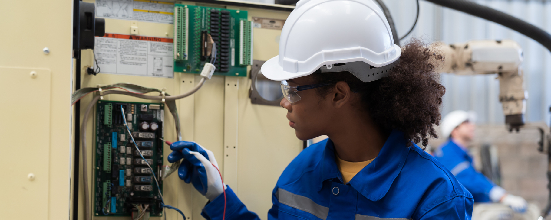Electrician worker checking operation electric system on circuit board in factory