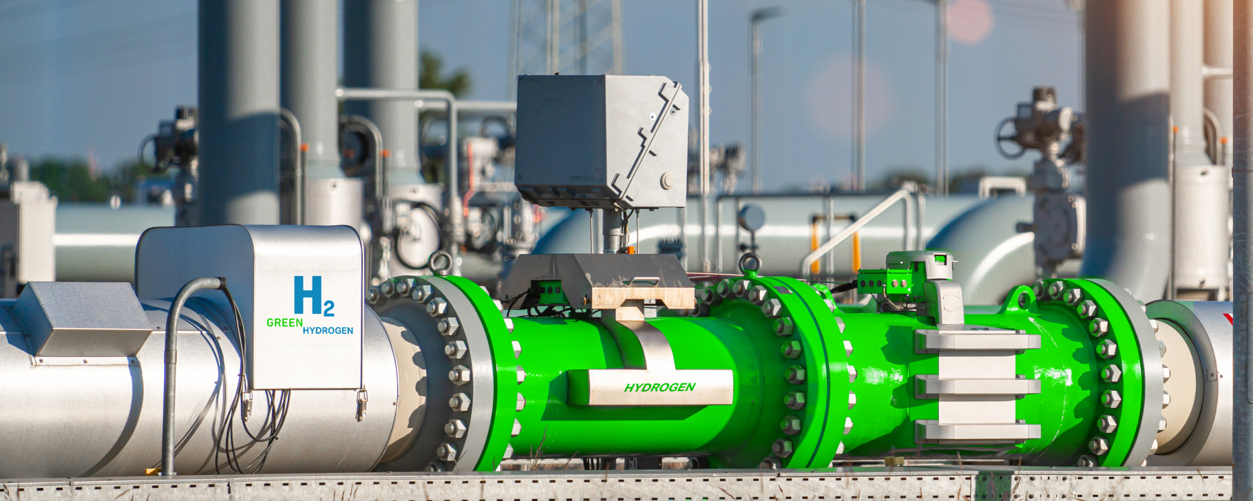 Green-painted industrial pipeline labeled 