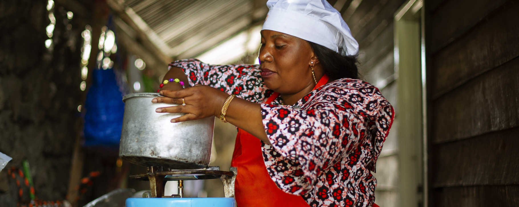 Person cooking a meal on a gas stove in a household kitchen.