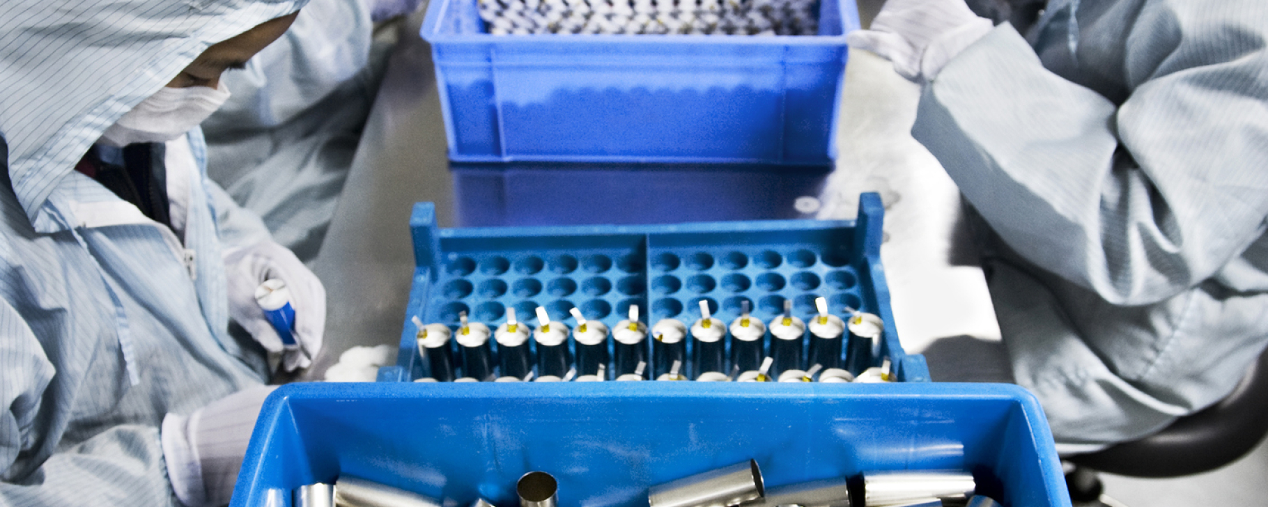 People in a factory working on batteries