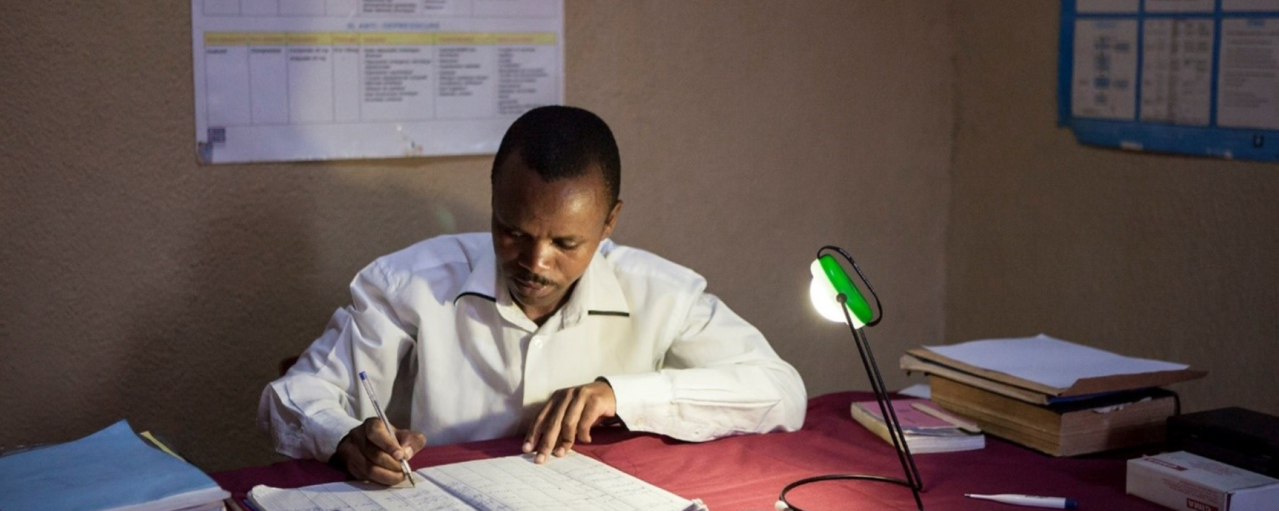 doctor working under the light of a lamp