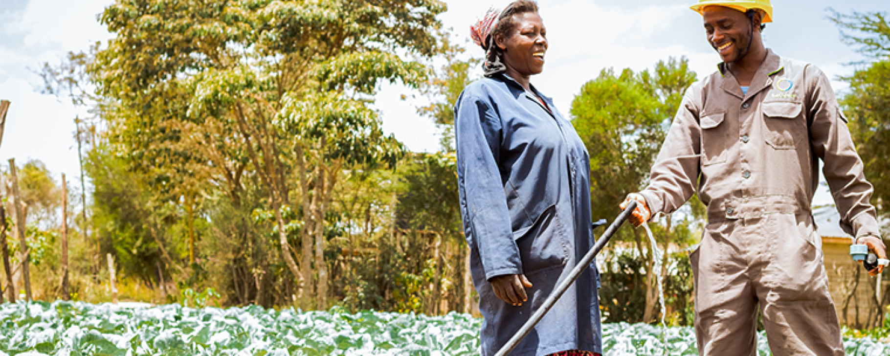 woman and man irrigating rural farm Photo credit: Sunculture.