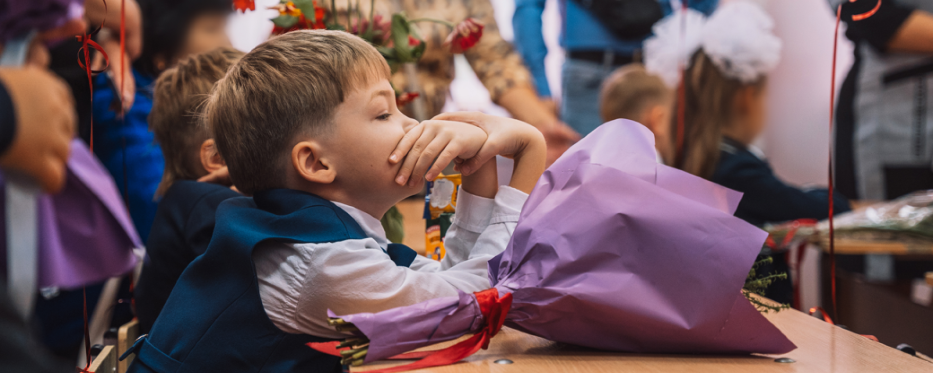 Shifting to a More Competitive, Greener, and Inclusive Economy with World Bank Support Close-up image of a young boy sitting in a classroom with a floral bouquet on his desk