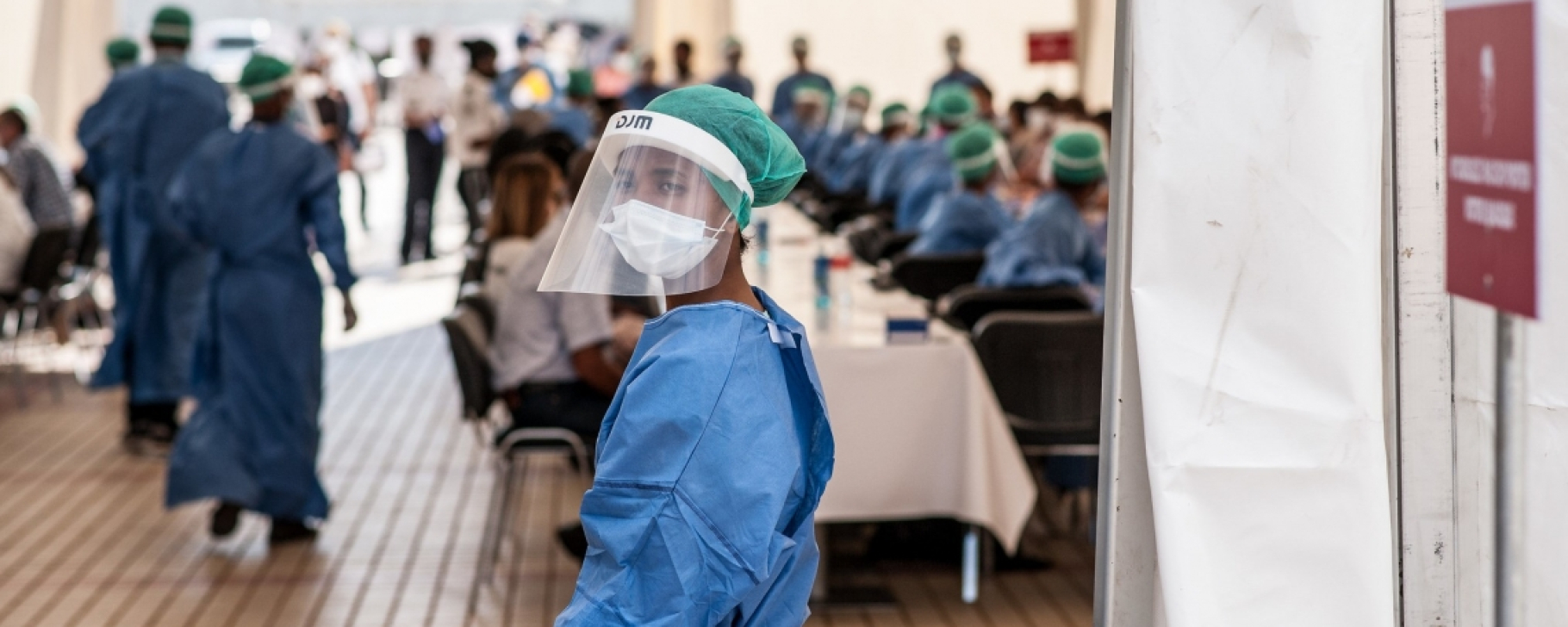 Efficient, Clean Cooling Program: Sustainable Cold Chains Amid COVID-19 Woman wearing scrubs and facial mask in Madagascar at a Covid-19 testing facility