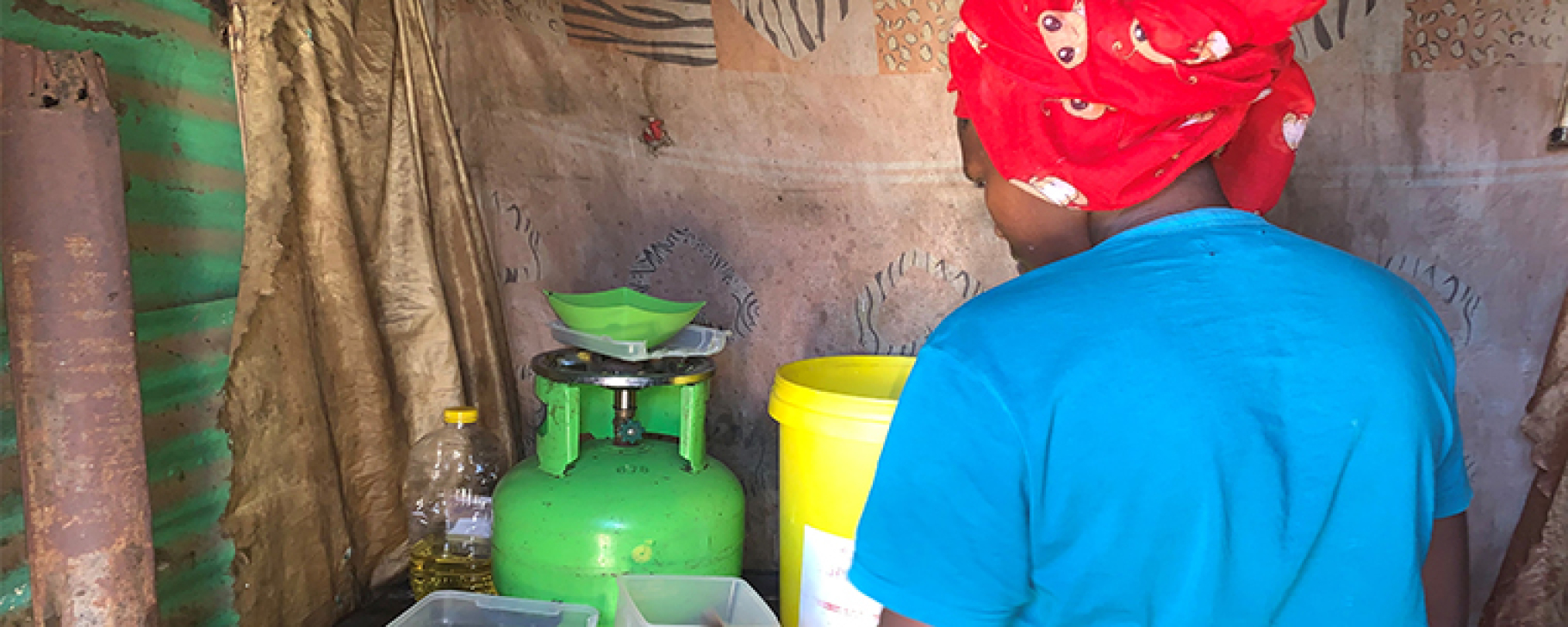 Soweto_Settement_Woman_Cooking_MarjorieAraya Woman cooking in a settlement in Soweto, South Africa