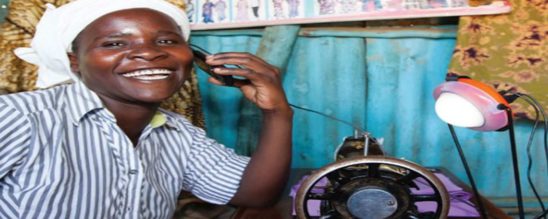 Off-Grid Solar Market Trends Report 2020 African woman in a blue shirt next to an offgrid power supply system