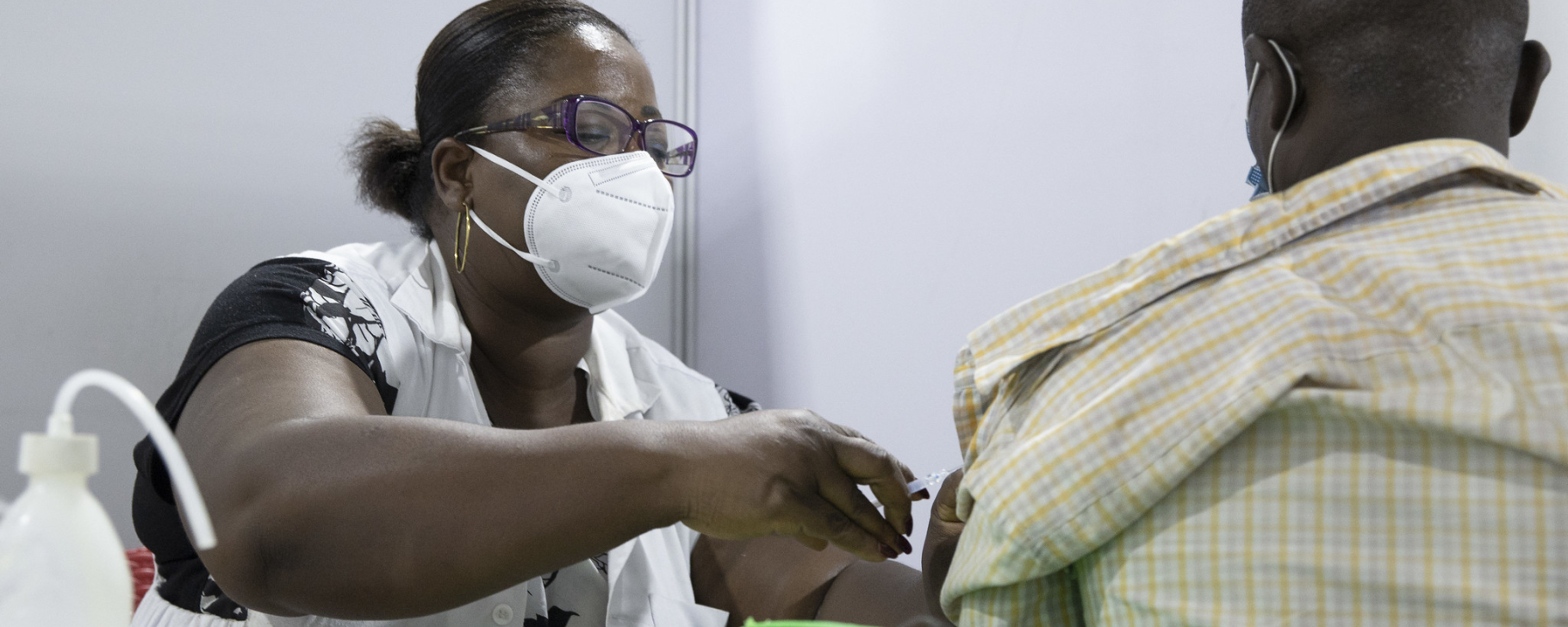 Nurse vaccinating man, Africa