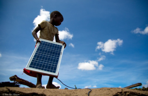 girl holding solar photovoltaic panel, image by Pawame