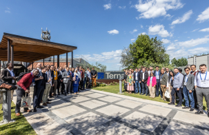 Group of participants posing outdoors beside a Terna sign during a technical study visit.