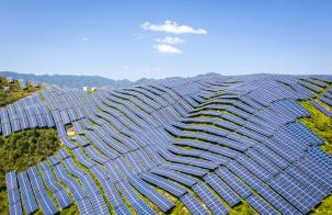 Accelerating Universal Energy Access by 2030 and Advancing Decarbonization Aerial shot of mountain slopes covered with photovoltaic panels