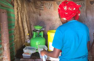 Soweto_Settement_Woman_Cooking_MarjorieAraya Woman cooking in a settlement in Soweto, South Africa
