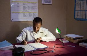 doctor working under the light of a lamp