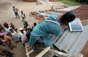 Togolese Solar Mamas successfully install a solar system, making their village clinic off-grid. Photograph by Lar Bolands.