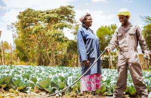 woman and man irrigating rural farm Photo credit: Sunculture.