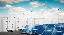 energy storage, batteries and wind turbines in a field