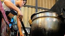 Laos, woman cooking