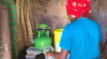 Woman cooking in a settlement in Soweto, South Africa 