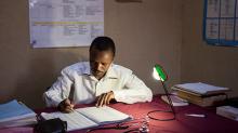 doctor working under the light of a lamp