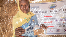 African woman displaying receipt from her cash transfer