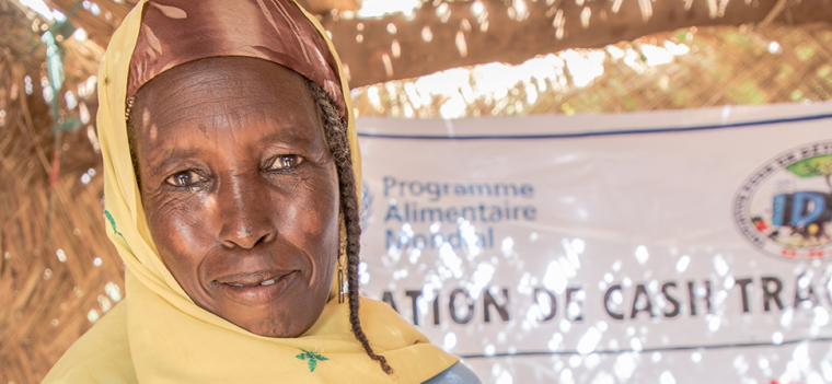 african woman displaying receipt from her cash transfer