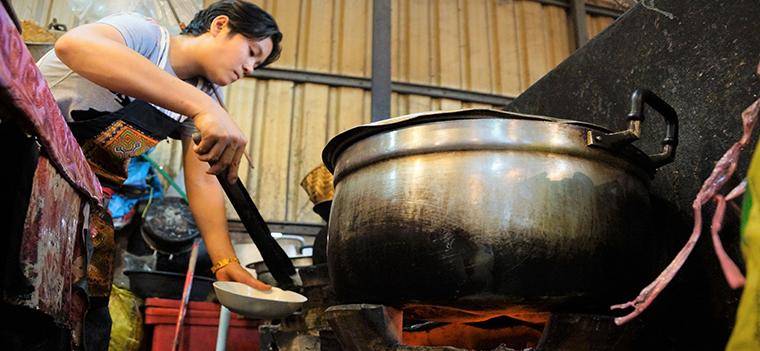 Laos, woman cooking