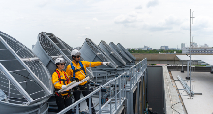 Construction worker performing cooling system repair