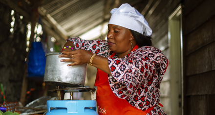 Person cooking a meal on a gas stove in a household kitchen.