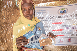 African woman displaying receipt from her cash transfer