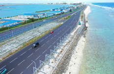 Highway bordered by turquoise water on both sides