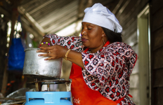 Person cooking a meal on a gas stove in a household kitchen.