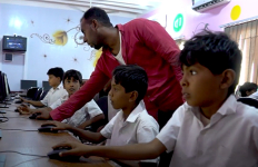 children working on computers in a school in Yemen
