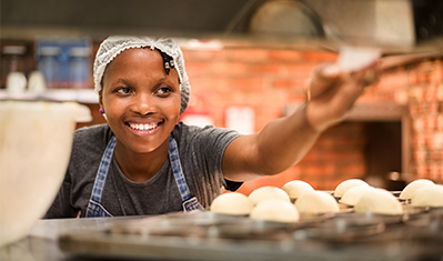 Young girl making bread, store, South Africa